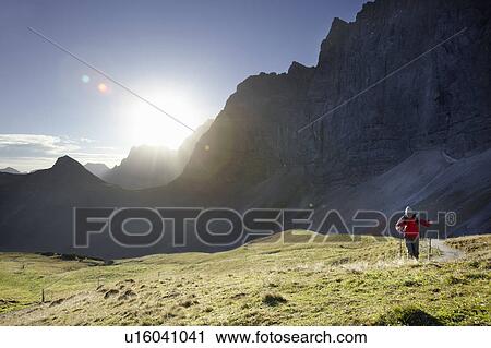 Stock Image - Man enjoying hill walk. Fotosearch