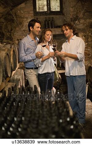 Man explains wine to couple View Large Photo Image Stock Photo - Man explains wine to couple. Fotosearch