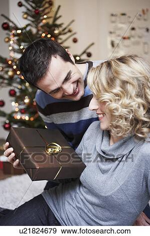 Man giving woman a present View Large Photo Image Stock Photo - Man giving woman a present. Fotosearch