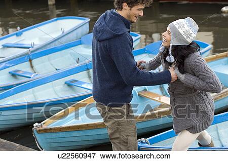 Man helping woman off boat View Large Photo Image Stock Photo - Man helping woman off boat. Fotosearch