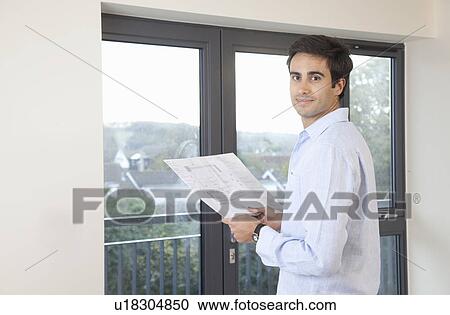 Man holding plans new apartment View Large Photo Image Stock Image - Man holding plans new apartment. Fotosearch