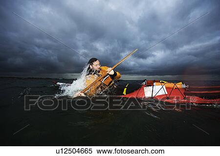 Stock Photography - Man in kayak rotating. Fotosearch