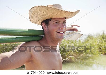 Man in straw hat looking across lake View Large Photo Image Stock Image - Man in straw hat looking across lake. Fotosearch