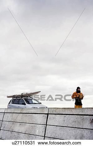 Man infront of car with kayak View Large Photo Image Stock Image - Man infront of car with kayak. Fotosearch