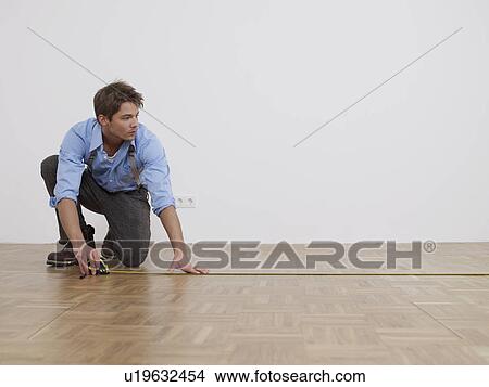Man is measuring View Large Photo Image Picture - Man is measuring. Fotosearch