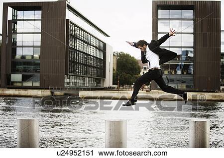 Man jumping from pole to pole View Large Photo Image Stock Image - Man jumping from pole to pole. Fotosearch