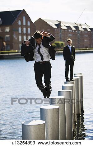 Man jumping from pole to pole View Large Photo Image Stock Photo - Man jumping from pole to pole. Fotosearch