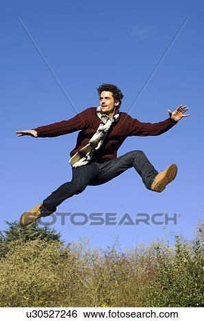 Man jumping in air View Large Photo Image Stock Photograph - Man jumping in air. Fotosearch