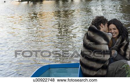 Man kissing woman on cheek on boat View Large Photo Image Stock Photo - Man kissing woman on cheek on boat. Fotosearch
