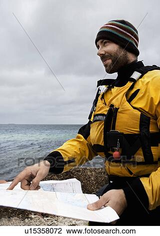 Stock Image - Man looking at map. Fotosearch