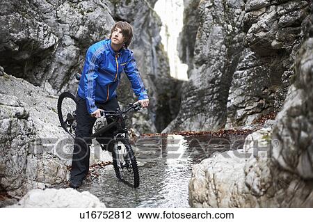 Man on mountain bike in mountains View Large Photo Image Stock Image - Man on mountain bike in mountains. Fotosearch