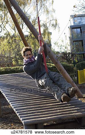 Stock Photo - Man on swing. Fotosearch