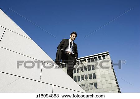 Stock Image - Man on wall. Fotosearch