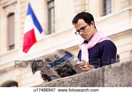 Man reads newspaper in Paris View Large Photo Image Stock Photo - Man reads newspaper in Paris. Fotosearch