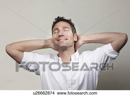 Man relaxes and smiles with closed eyes View Large Photo Image Picture - Man relaxes and smiles with closed eyes. Fotosearch