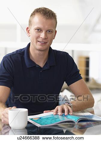 Man relaxing at home with hot drink View Large Photo Image Stock Photo - Man relaxing at home with hot drink. Fotosearch