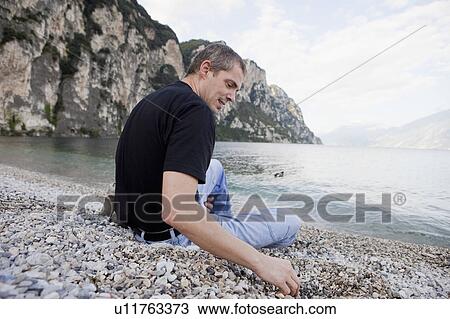 Man relaxing by the water View Large Photo Image Stock Image - Man relaxing by the water. Fotosearch