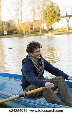Stock Photo - Man rowing row boat. Fotosearch