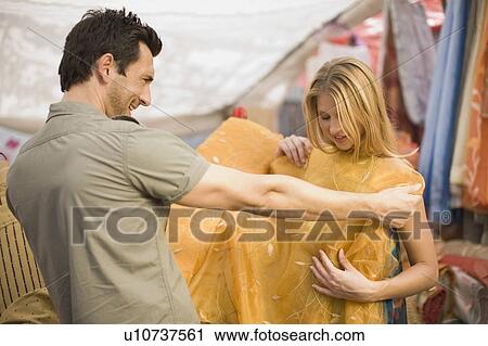 Stock Image - Man selling cloth. Fotosearch