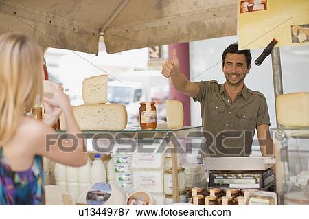 Man selling dairy products View Large Photo Image Stock Photo - Man selling dairy products. Fotosearch