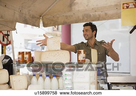 Stock Photo - Man selling dairy products. Fotosearch