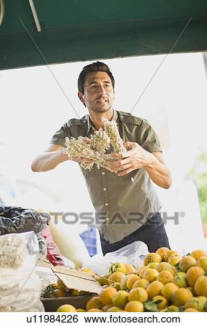 Stock Photograph - Man selling fruits. Fotosearch