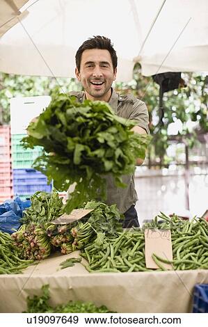 Man selling vegetables View Large Photo Image Stock Photo - Man selling vegetables. Fotosearch