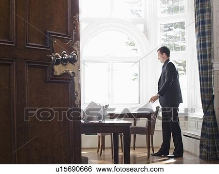 Man setting up table View Large Photo Image Stock Photograph - Man setting up table. Fotosearch