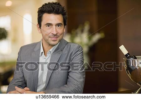 Stock Photograph - Man sitting at bar. Fotosearch