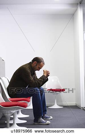 Man sitting in his doctor's waiting room View Large Photo Image Stock Photograph - Man sitting in his doctor's waiting room. Fotosearch