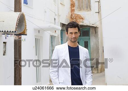 Stock Photograph - Man standing in an alley. Fotosearch