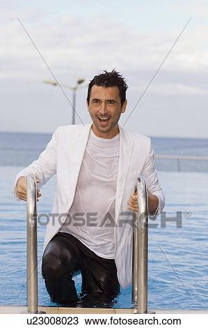 Man stepping out of the pool View Large Photo Image Stock Image - Man stepping out of the pool. Fotosearch