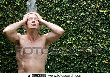 Man taking a shower outside View Large Photo Image Stock Photo - Man taking a shower outside. Fotosearch