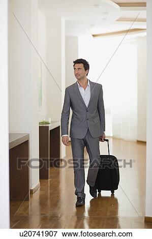 Man walking through hotel View Large Photo Image Stock Photo - Man walking through hotel. Fotosearch