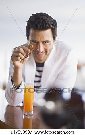Stock Photo - Man with key at bar. Fotosearch