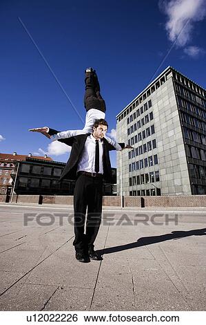 Stock Photograph - Man with woman on shoulder. Fotosearch
