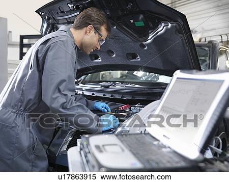 Mechanic working on engine analysis View Large Photo Image Stock Photography - Mechanic working on engine analysis. Fotosearch