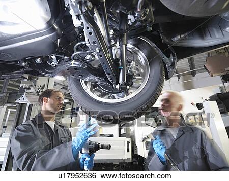 Stock Photograph - Mechanic working under car. Fotosearch