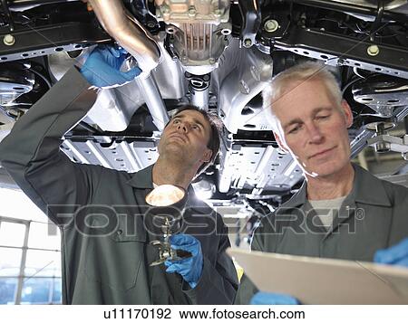 Mechanics working under car View Large Photo Image Stock Image - Mechanics working under car. Fotosearch