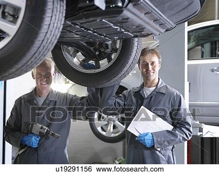 Mechanics working under car View Large Photo Image Stock Photograph - Mechanics working under car. Fotosearch