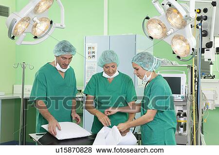 Medical team in scrubs preparing room View Large Photo Image Stock Photo - Medical team in scrubs preparing room. Fotosearch