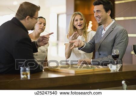 Stock Image - Men playing at bar. Fotosearch