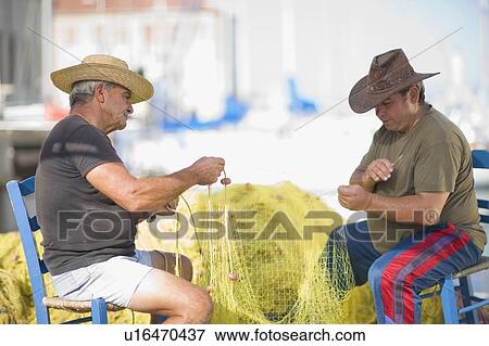 Men preparing fishing net View Large Photo Image Stock Photo - Men preparing fishing net. Fotosearch