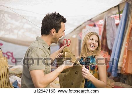 Stock Image - Men selling cloth. Fotosearch
