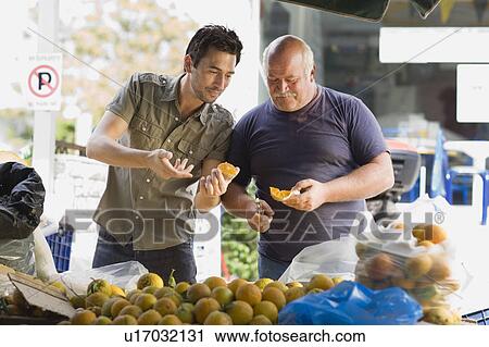 Men selling fruits View Large Photo Image Stock Image - Men selling fruits. Fotosearch