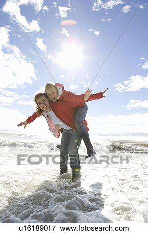 Mom and daughter at beach piggyback ride View Large Photo Image Stock Photo - Mom and daughter at beach piggyback ride. Fotosearch