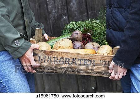 Mother and daughter carrying vegetables View Large Photo Image Stock Image - Mother and daughter carrying vegetables. Fotosearch