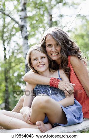 Stock Image - Mother and daughter cuddling. Fotosearch