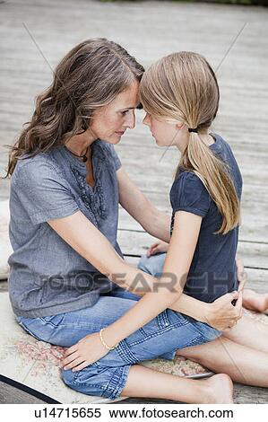 Mother and daughter cuddling View Large Photo Image Stock Photography - Mother and daughter cuddling. Fotosearch