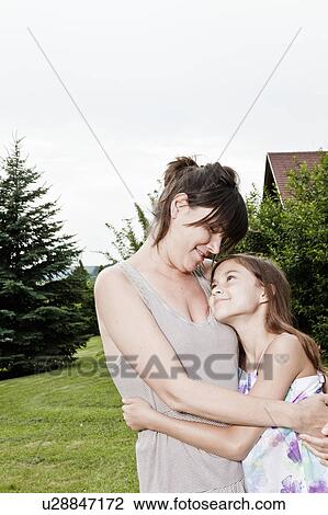 Stock Image - Mother and daughter hug. Fotosearch